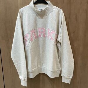 PARKE Women's Turtleneck Sweater in Cream with Pink Lettering